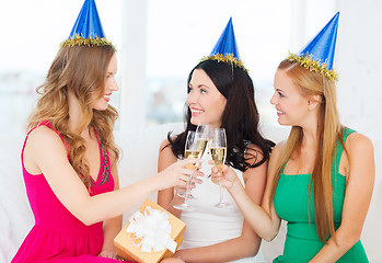 Image showing three women wearing hats with champagne glasses