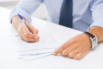 Image showing man signing a contract