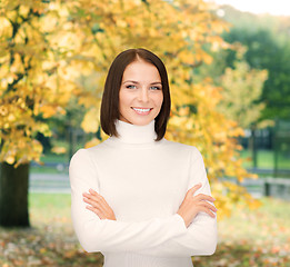 Image showing smiling woman in white sweater