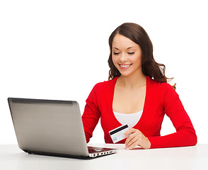 Image showing happy woman with laptop computer and credit card