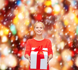 Image showing smiling woman in red sweater with gift box