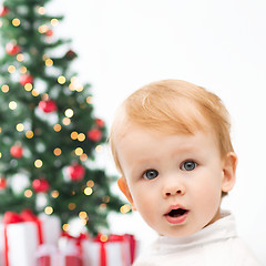 Image showing happy little boy with christmas tree and gifts