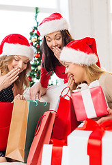 Image showing women in santa helper hats with shopping bags