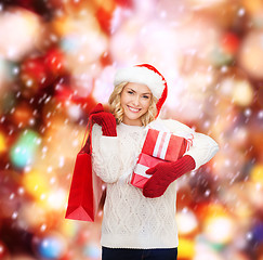 Image showing woman in santa helper hat with shopping bags