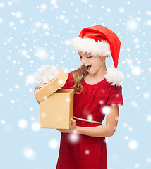 Image showing smiling girl in santa helper hat with gift box