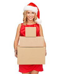 Image showing smiling woman in santa helper hat with parcels