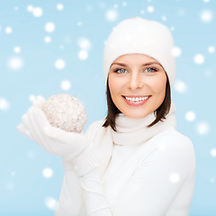 Image showing woman in hat, scarf and gloves with christmas ball