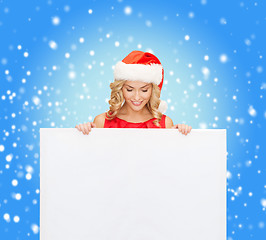 Image showing woman in santa helper hat with blank white board