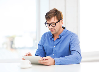 Image showing man working with tablet pc at home