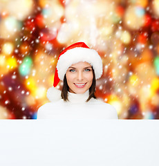 Image showing woman in santa helper hat with blank white board