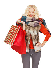 Image showing teenage girl in winter clothes with shopping bags