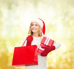 Image showing woman in santa helper hat with shopping bags