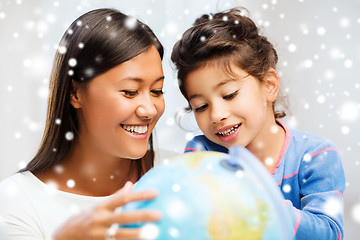 Image showing mother and daughter with globe