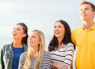 Image showing group of friends looking up on the beach