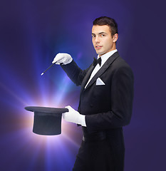 Image showing magician in top hat with magic wand showing trick