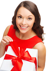 Image showing smiling woman in red dress with gift box