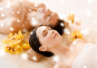 Image showing couple in spa salon lying on the massage desks