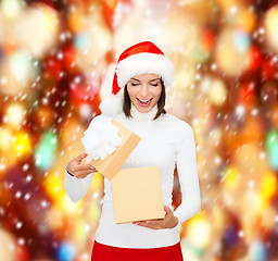 Image showing surprised woman in santa helper hat with gift box