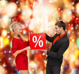 Image showing smiling woman and man with red percent sale sign