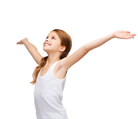 Image showing smiling teenage girl with raised hands