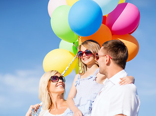 Image showing family with colorful balloons