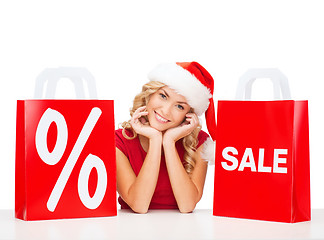 Image showing woman in red dress with shopping bags