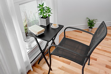 Image showing Chair and table in a room with green plants