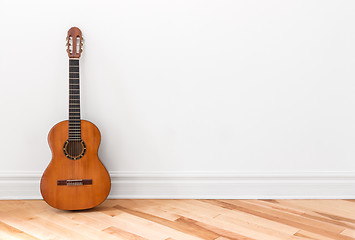 Image showing Classical guitar in an empty room