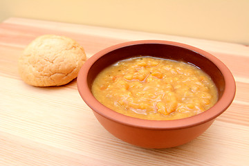 Image showing Chunky vegetable soup with a bread roll