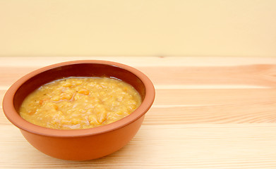 Image showing Closeup of bowl of vegetable soup on a wooden table
