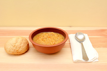 Image showing Vegetable soup in a bowl with crusty bread roll