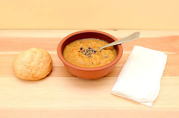 Image showing Lentil soup in a bowl with seasoning and bread roll