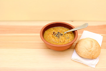 Image showing Vegetable soup served with seasoning and bread roll