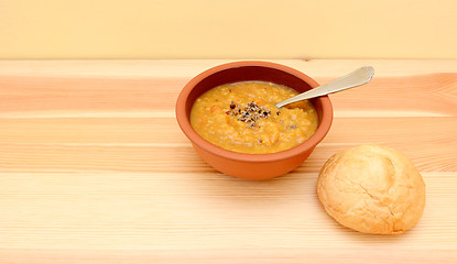 Image showing Seasoned lentil soup with a crusty bread roll