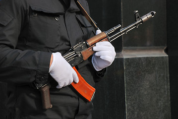 Image showing hands in white gloves with a Kalashnikov 