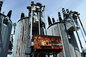 Image showing old rusty transformer substation against the blue sky