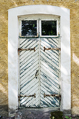 Image showing wooden white door with wrought-iron hinges