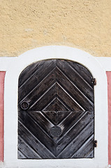 Image showing wooden door with wrought-iron hinges and ring