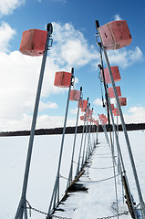 Image showing empty boat park on lake in winter under the snow