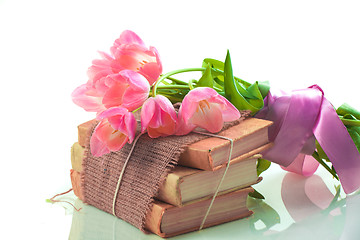 Image showing Pink tulips on old books