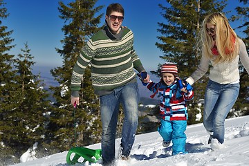 Image showing family having fun on fresh snow at winter vacation