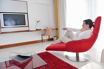 Image showing happy young woman relax at home on sofa