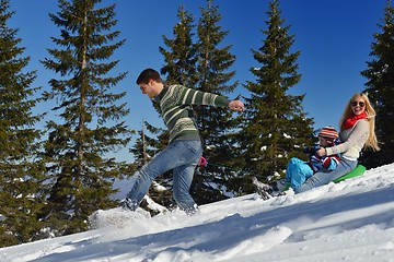 Image showing family having fun on fresh snow at winter vacation