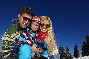 Image showing family having fun on fresh snow at winter vacation