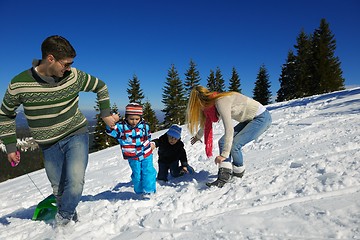 Image showing family having fun on fresh snow at winter vacation