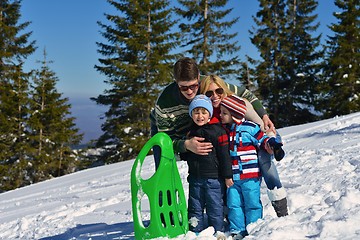 Image showing family having fun on fresh snow at winter vacation