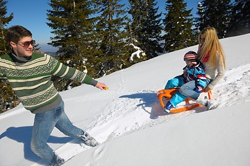 Image showing family having fun on fresh snow at winter vacation