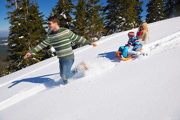 Image showing family having fun on fresh snow at winter vacation