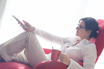 Image showing happy young woman relax at home on sofa