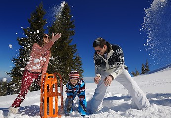 Image showing family having fun on fresh snow at winter vacation